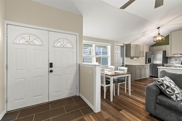 12516 Cobble Stone Dr, Hudson, FL 34667 - entryway with ceiling fan, lofted ceiling, dark wood-style floors, and a chandelier