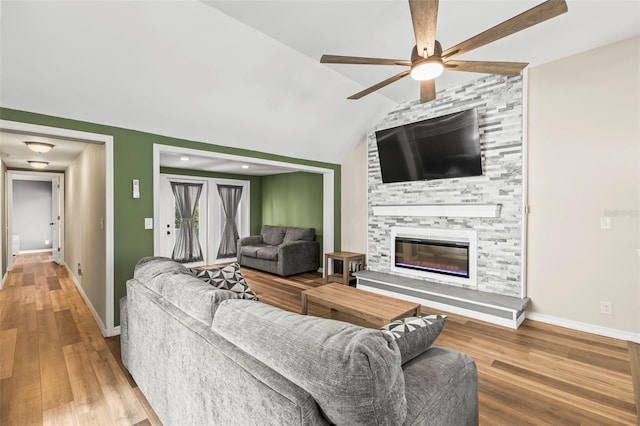 12516 Cobble Stone Dr, Hudson, FL 34667 - living room featuring a ceiling fan, wood finished floors, baseboards, a fireplace, and lofted ceiling