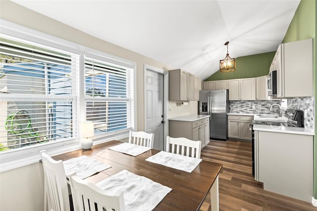 12516 Cobble Stone Dr, Hudson, FL 34667 - dining area with dark wood-style floors and lofted ceiling