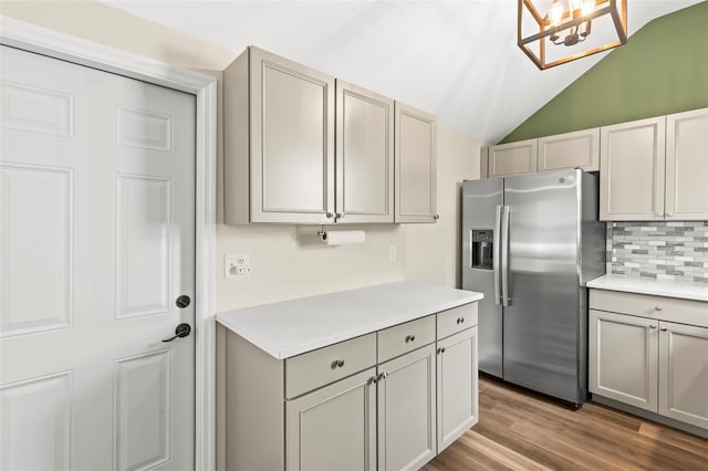 12516 Cobble Stone Dr, Hudson, FL 34667 - kitchen with stainless steel fridge with ice dispenser, decorative backsplash, light countertops, vaulted ceiling, and gray cabinets