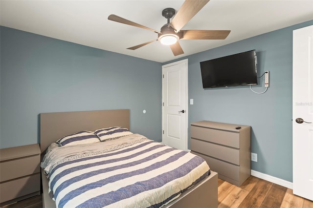 12516 Cobble Stone Dr, Hudson, FL 34667 - bedroom featuring wood finished floors, ceiling fan, and baseboards