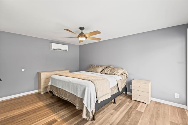 12516 Cobble Stone Dr, Hudson, FL 34667 - bedroom featuring a wall mounted AC, wood finished floors, baseboards, and ceiling fan