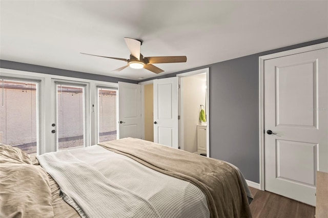 12516 Cobble Stone Dr, Hudson, FL 34667 - bedroom with dark wood-style flooring, baseboards, ceiling fan, and ensuite bathroom