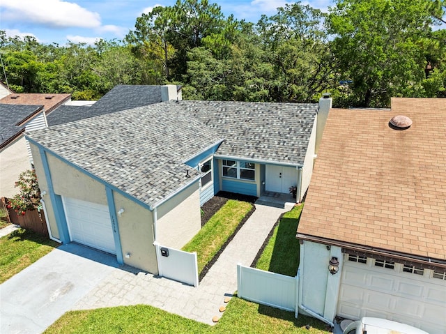 12516 Cobble Stone Dr, Hudson, FL 34667 - view of front of home with a shingled roof, concrete driveway, a garage, and a chimney