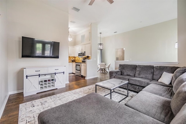 501 Knights Run Ave Unit 6104, Tampa, FL 33602 - living room with dark wood-type flooring, a ceiling fan, baseboards, and a high ceiling