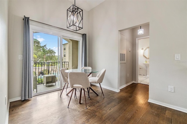 501 Knights Run Ave Unit 6104, Tampa, FL 33602 - dining room featuring dark wood finished floors, baseboards, and a towering ceiling