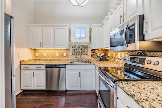 501 Knights Run Ave Unit 6104, Tampa, FL 33602 - kitchen featuring stainless steel appliances, a sink, dark wood-type flooring, white cabinetry, and decorative backsplash