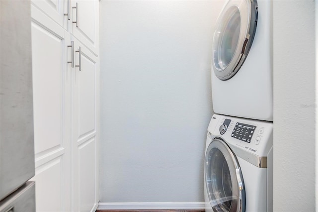 501 Knights Run Ave Unit 6104, Tampa, FL 33602 - laundry room with stacked washer / dryer, cabinet space, and baseboards