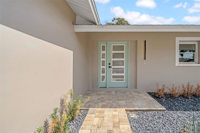 8433 101st Ave, Seminole, FL 33777 - doorway to property with stucco siding and a patio area