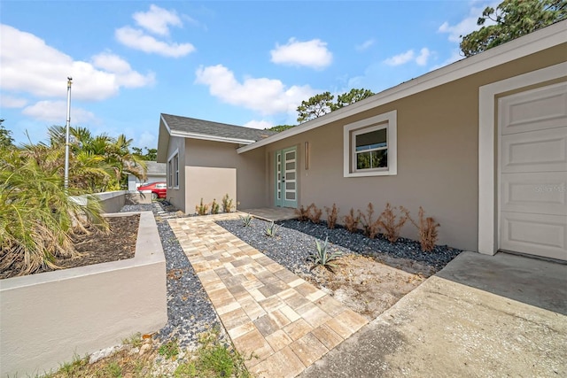 8433 101st Ave, Seminole, FL 33777 - view of property exterior with stucco siding and roof with shingles