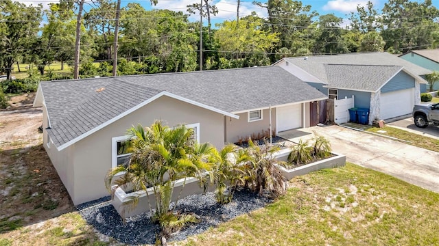 8433 101st Ave, Seminole, FL 33777 - view of front of house with an attached garage, roof with shingles, stucco siding, and driveway