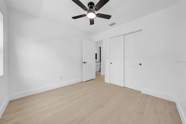 8433 101st Ave, Seminole, FL 33777 - unfurnished bedroom featuring light wood-style floors, baseboards, a closet, and ceiling fan