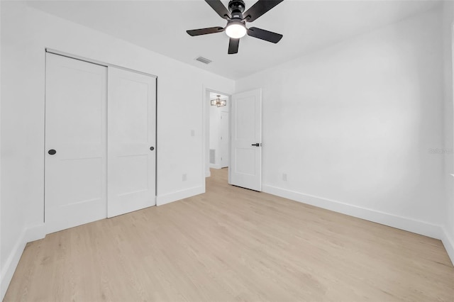 8433 101st Ave, Seminole, FL 33777 - unfurnished bedroom with light wood finished floors, baseboards, a closet, and ceiling fan
