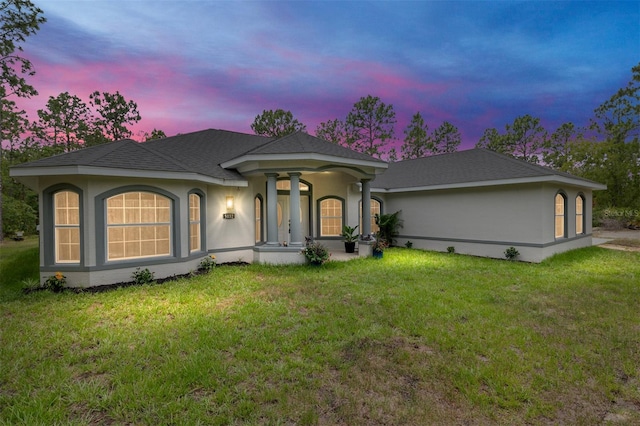 5032 N Crossgate Pt, Beverly Hills, FL 34465 - view of front of home with a front lawn and stucco siding