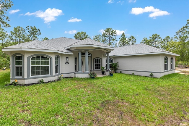 5032 N Crossgate Pt, Beverly Hills, FL 34465 - view of front facade with a front yard and stucco siding