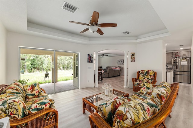 5032 N Crossgate Pt, Beverly Hills, FL 34465 - living room featuring a ceiling fan, a raised ceiling, ornate columns, arched walkways, and recessed lighting