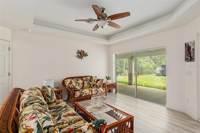 5032 N Crossgate Pt, Beverly Hills, FL 34465 - living room featuring a raised ceiling, wood finished floors, ceiling fan, and baseboards