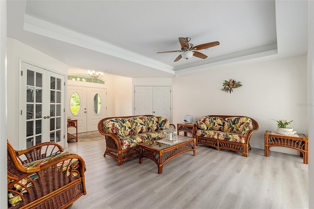 5032 N Crossgate Pt, Beverly Hills, FL 34465 - living area featuring a tray ceiling, wood finished floors, ceiling fan, a chandelier, and french doors