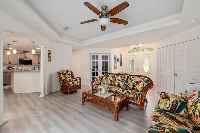 5032 N Crossgate Pt, Beverly Hills, FL 34465 - living area featuring a raised ceiling, french doors, light wood-type flooring, decorative columns, and arched walkways