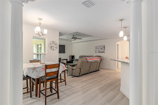 5032 N Crossgate Pt, Beverly Hills, FL 34465 - dining room featuring light wood finished floors, a tray ceiling, arched walkways, ceiling fan, and ornate columns