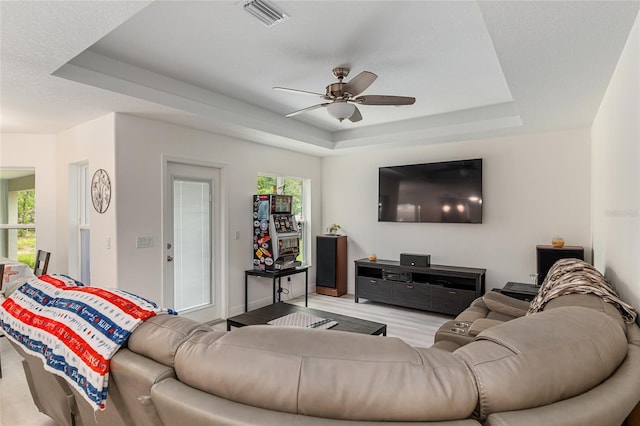 5032 N Crossgate Pt, Beverly Hills, FL 34465 - living room featuring a raised ceiling, a ceiling fan, wood finished floors, and baseboards