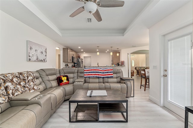 5032 N Crossgate Pt, Beverly Hills, FL 34465 - living room featuring arched walkways, a ceiling fan, a raised ceiling, light wood-type flooring, and recessed lighting