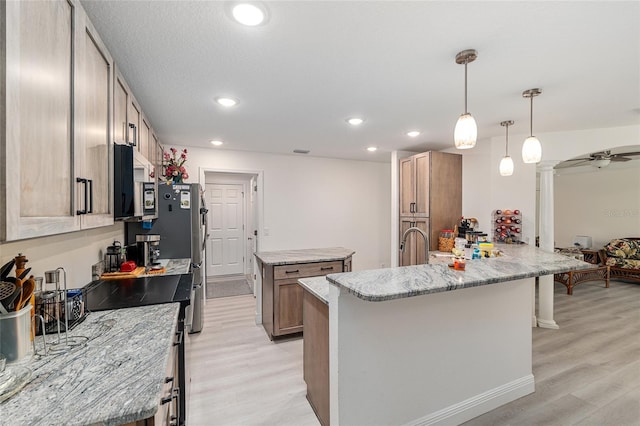5032 N Crossgate Pt, Beverly Hills, FL 34465 - kitchen with light wood-style floors, black electric range, a kitchen island, a peninsula, and light stone counters