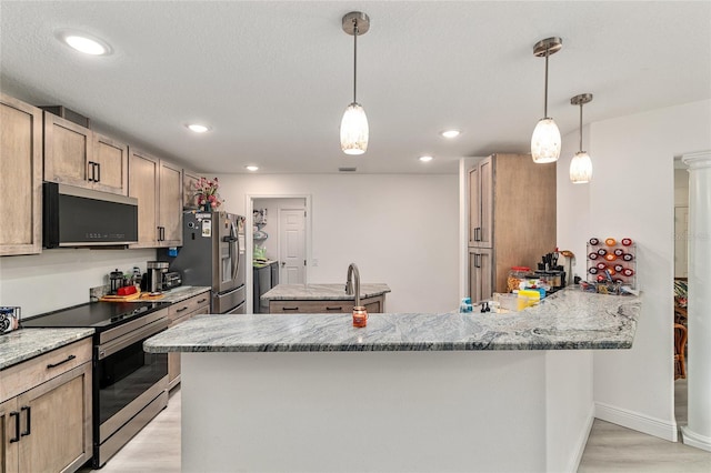 5032 N Crossgate Pt, Beverly Hills, FL 34465 - kitchen featuring stainless steel appliances, a kitchen island, light stone countertops, light wood-style floors, and a peninsula