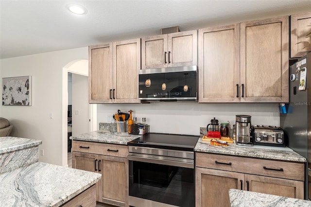 5032 N Crossgate Pt, Beverly Hills, FL 34465 - kitchen with stainless steel appliances, arched walkways, light stone counters, and recessed lighting