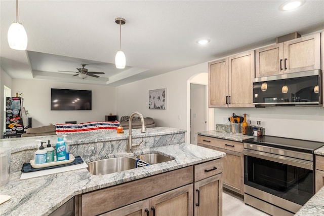 5032 N Crossgate Pt, Beverly Hills, FL 34465 - kitchen with appliances with stainless steel finishes, a sink, open floor plan, arched walkways, and light stone counters
