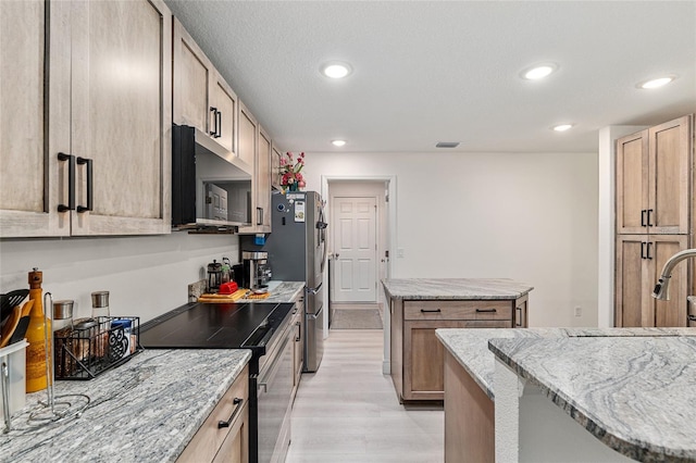 5032 N Crossgate Pt, Beverly Hills, FL 34465 - kitchen with appliances with stainless steel finishes, a kitchen island, light wood finished floors, recessed lighting, and light stone counters