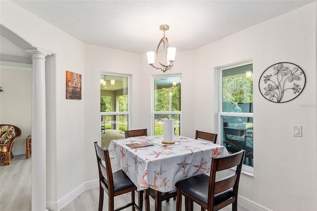 5032 N Crossgate Pt, Beverly Hills, FL 34465 - dining space featuring light wood-style floors, baseboards, and decorative columns