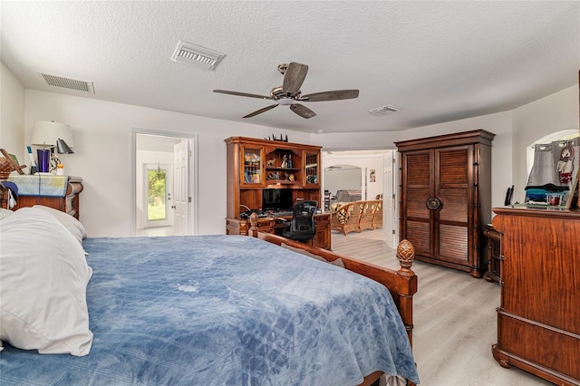 5032 N Crossgate Pt, Beverly Hills, FL 34465 - bedroom with light wood finished floors, a ceiling fan, and a textured ceiling