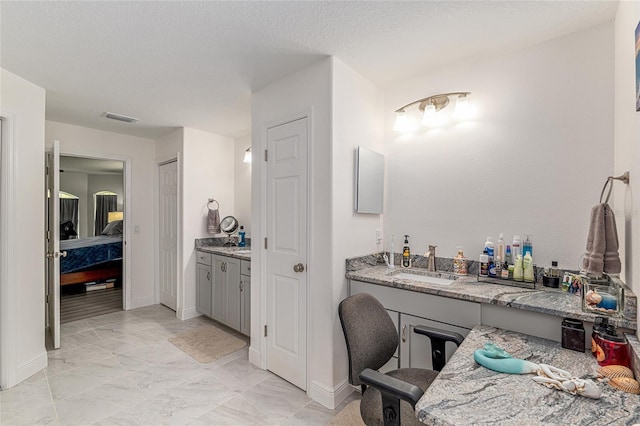 5032 N Crossgate Pt, Beverly Hills, FL 34465 - ensuite bathroom featuring vanity, baseboards, and marble finish flooring