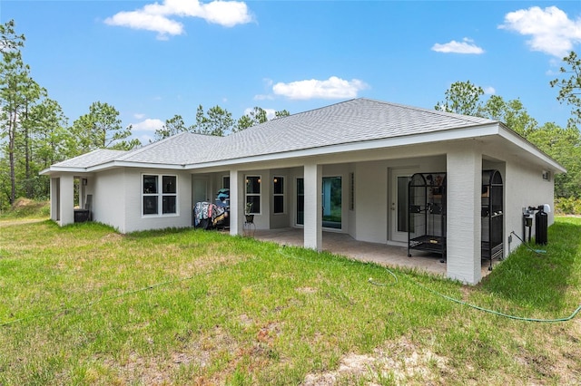 5032 N Crossgate Pt, Beverly Hills, FL 34465 - rear view of property with a patio and a yard