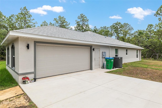 5032 N Crossgate Pt, Beverly Hills, FL 34465 - view of property exterior with central AC, driveway, a shingled roof, and a garage