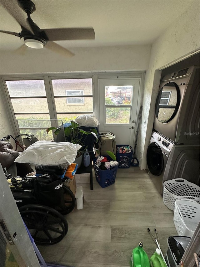 601 N Hercules Ave Unit 1008, Clearwater, FL 33765 - washroom featuring estacked washer and dryer, wood finished floors, and a ceiling fan
