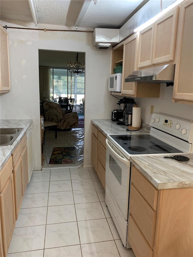 2901 NW 48th Ave Unit 367, Lauderdale Lakes, FL 33313 - kitchen with white appliances, under cabinet range hood, light brown cabinetry, and light countertops