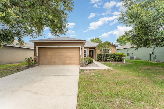 6898 Glenbrook Dr, Lakeland, FL 33811 - view of front of home featuring stucco siding, a garage, a front yard, driveway, and central AC unit