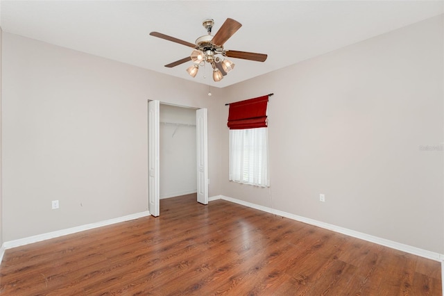 6898 Glenbrook Dr, Lakeland, FL 33811 - unfurnished bedroom with wood finished floors, baseboards, a ceiling fan, and a closet