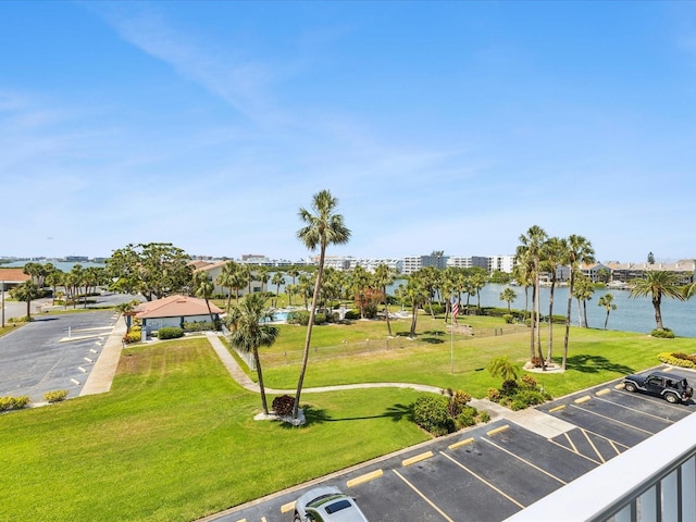 10216 Regal Dr Unit 409, Largo, FL 33774 - view of property's community with uncovered parking, a water view, and a lawn