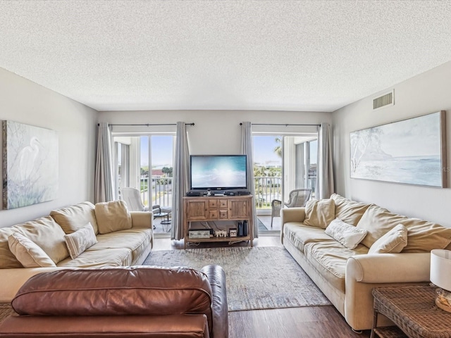 10216 Regal Dr Unit 409, Largo, FL 33774 - living area featuring wood finished floors, healthy amount of natural light, and a textured ceiling