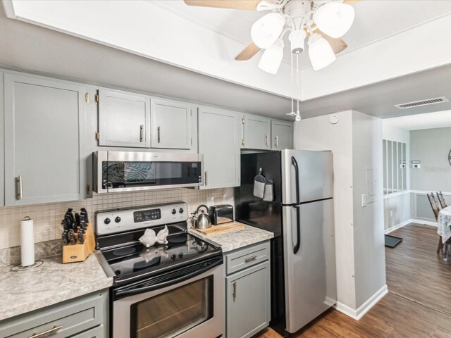 10216 Regal Dr Unit 409, Largo, FL 33774 - kitchen featuring appliances with stainless steel finishes, baseboards, gray cabinetry, and backsplash
