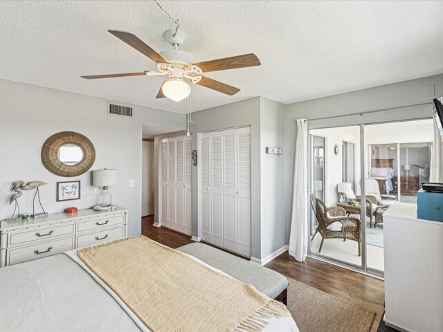 10216 Regal Dr Unit 409, Largo, FL 33774 - bedroom with dark wood-style flooring, a textured ceiling, a ceiling fan, and baseboards