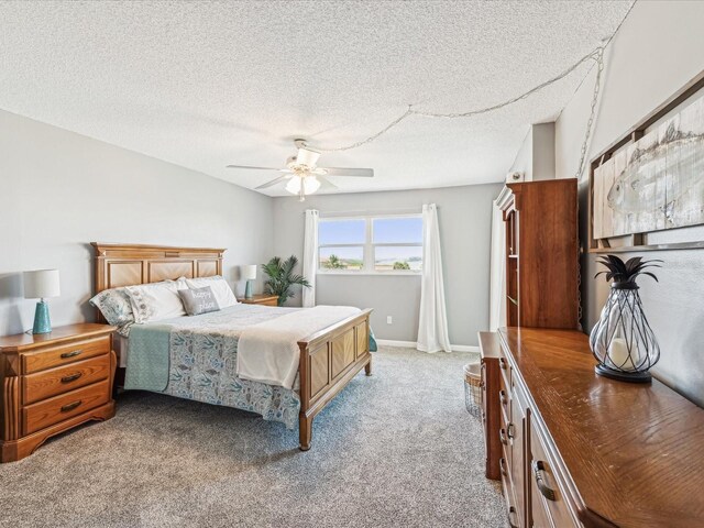 10216 Regal Dr Unit 409, Largo, FL 33774 - bedroom with light colored carpet, a ceiling fan, and a textured ceiling