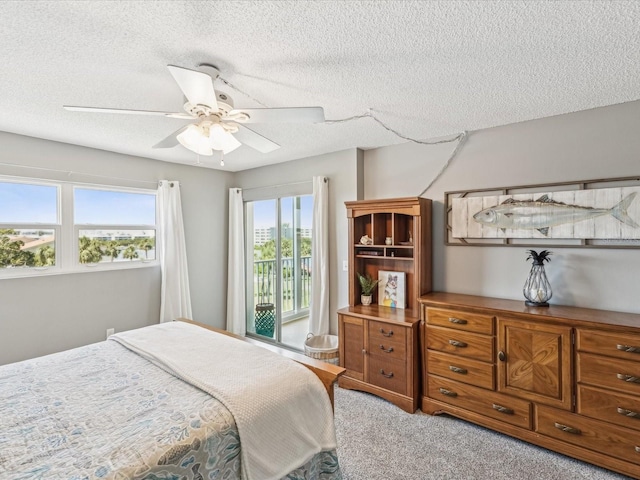 10216 Regal Dr Unit 409, Largo, FL 33774 - carpeted bedroom featuring access to exterior, a textured ceiling, and ceiling fan