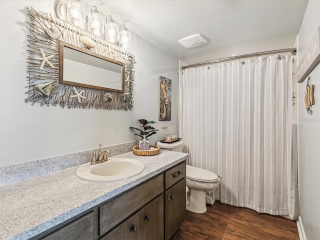 10216 Regal Dr Unit 409, Largo, FL 33774 - bathroom featuring toilet, vanity, wood finished floors, and a shower with shower curtain
