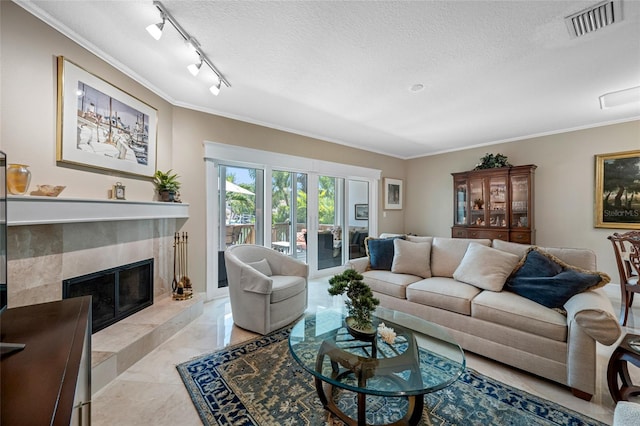 903 Pinellas Bayway S Unit 103, Tierra Verde, FL 33715 - living room with crown molding, a textured ceiling, a premium fireplace, light marble finish flooring, and track lighting