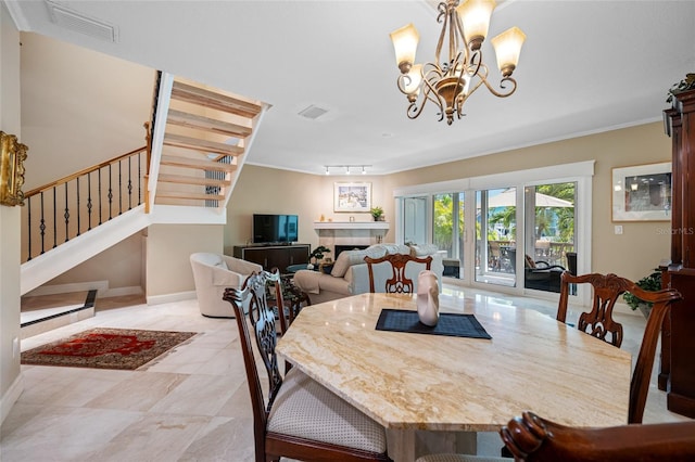 903 Pinellas Bayway S Unit 103, Tierra Verde, FL 33715 - dining room with stairs, a chandelier, baseboards, and a fireplace