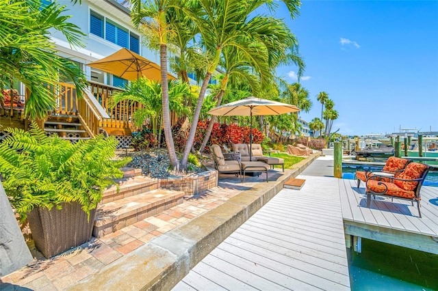 903 Pinellas Bayway S Unit 103, Tierra Verde, FL 33715 - wooden deck with a boat dock, stairs, and outdoor lounge area